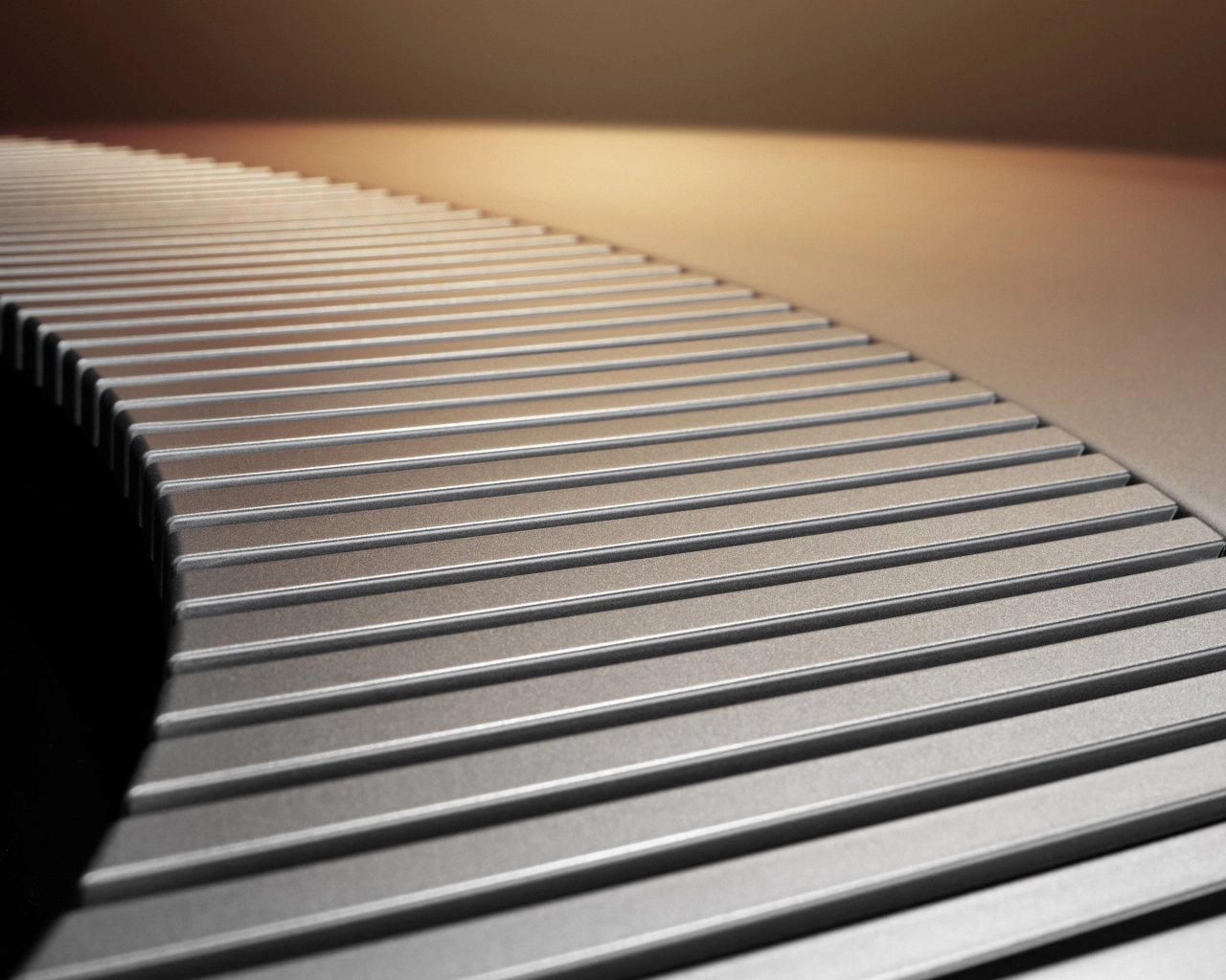 Close-up detail of parallel silver ribbed lines on the Jaguar Type 01's surface, catching warm overhead light