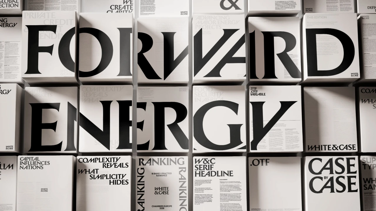 White & Case rebrand identity materials displayed on a grid wall, showing bold black typography and publication spreads featuring Catalyst Blue accents