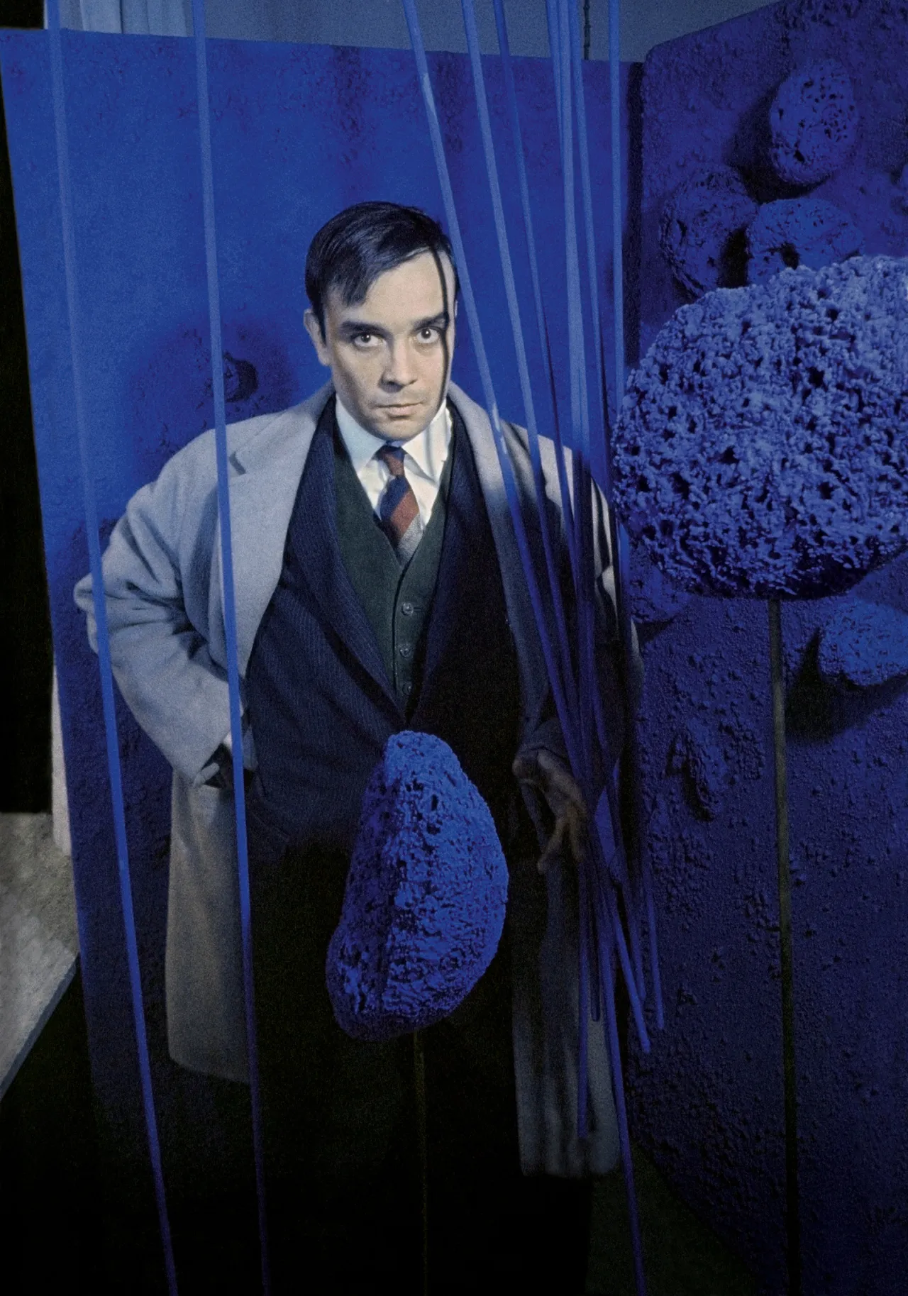 Yves Klein surrounded by his « Sponge Sculptures » during the opening of the exhibition "Monochrome und Feuer"  Haus Lange Museum, Krefeld, Germany, January 1961 © Yves Klein Estate, ADAGP, Paris / DACS, London, 2018 © Photo : Pierre Boulat