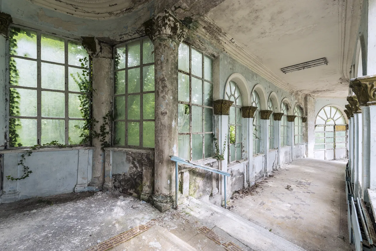 Nature is taking over this beautiful corridor. This passage connected the main thermal spa facilities with the private rooms of patients and guests. Tskaltubo, Georgia. © Reginald Van de Velde