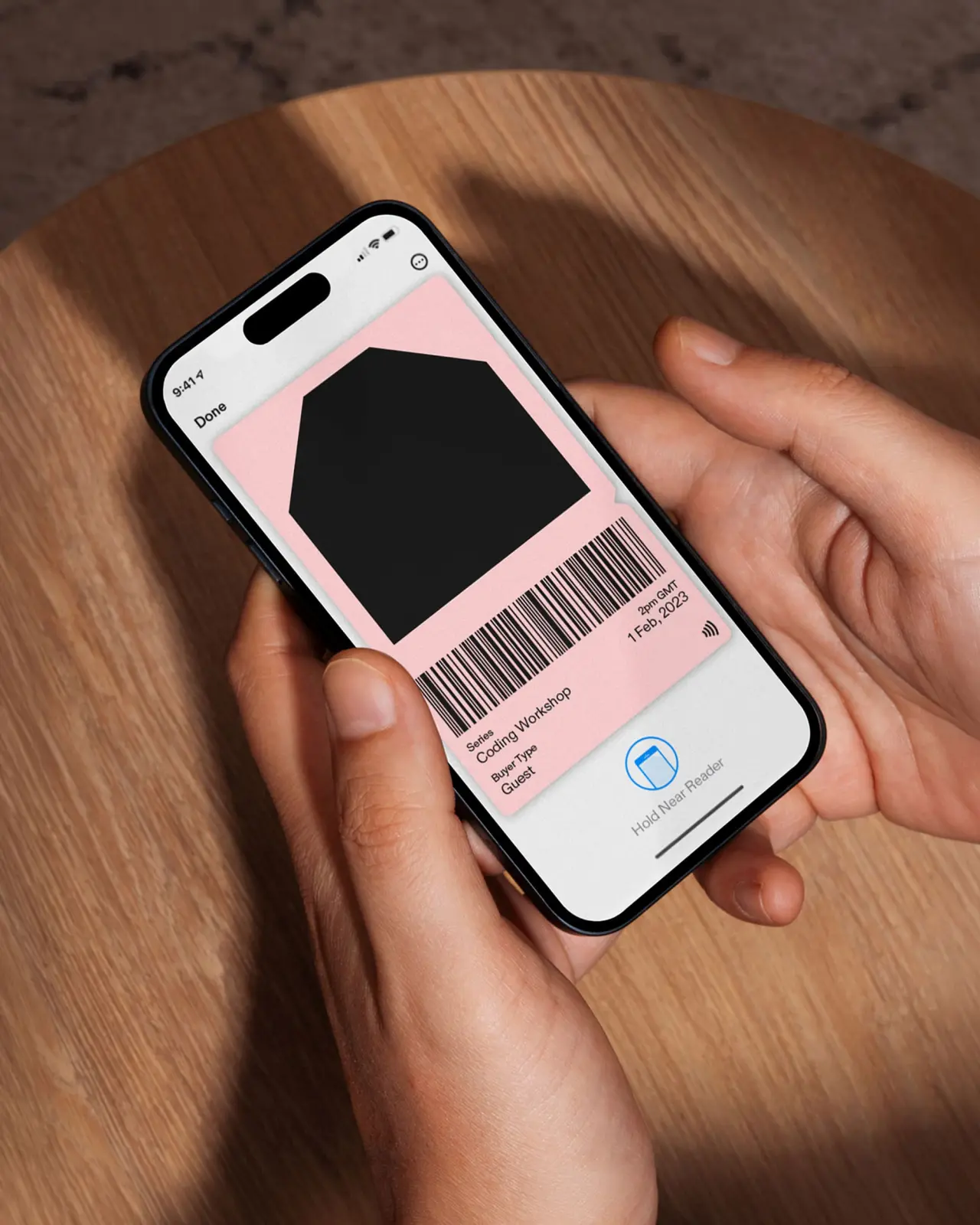 Hand holding a smartphone displaying Culture House Sunderland's digital pass with pink background and barcode