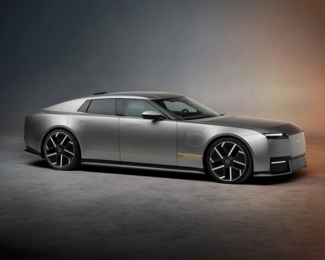 Silver Jaguar Type 01 luxury car shown in profile against a gradient grey and bronze background